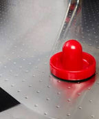 Close-up of a red pusher on the perforated metal playfield of the Heemskerk Navona
