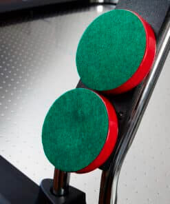 Two red pushers with green felt bases resting on the Heemskerk Navona playfield