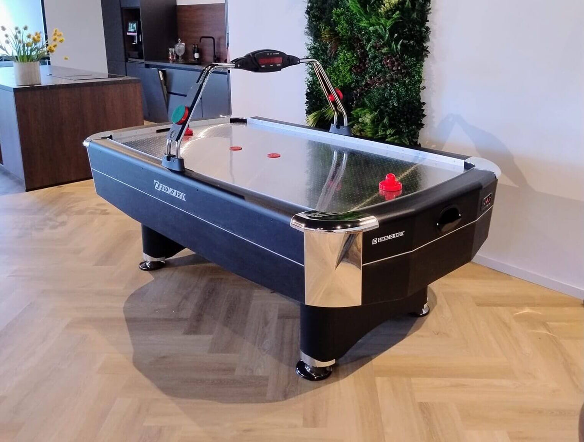 Side view of the Heemskerk Navona air hockey table on a herringbone wooden floor