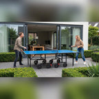 Couple playing on a Heemskerk Novi 2100 outdoor table tennis table on a patio
