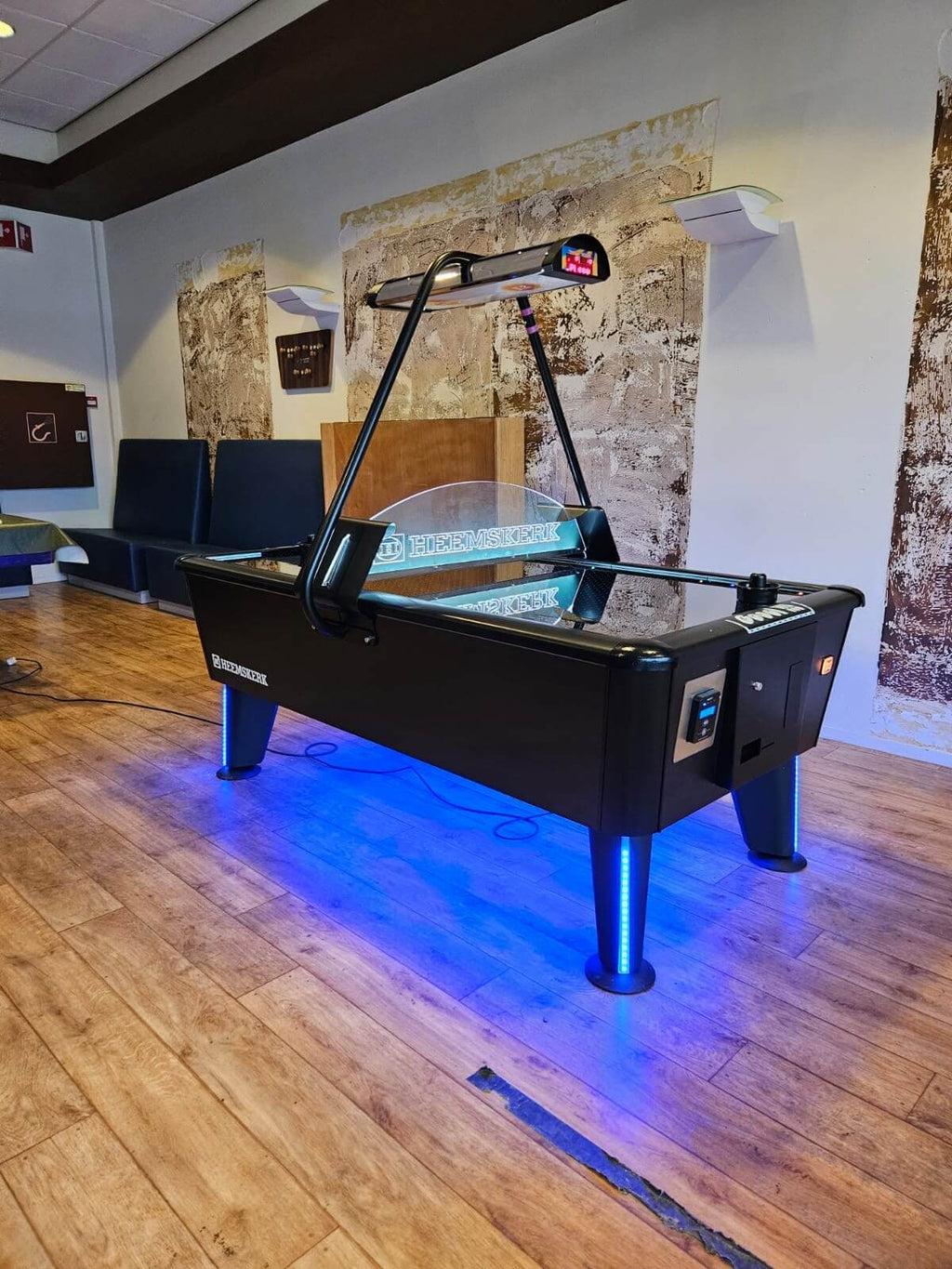 Heemskerk Parthenon air hockey table with blue LED-lit legs in a games room