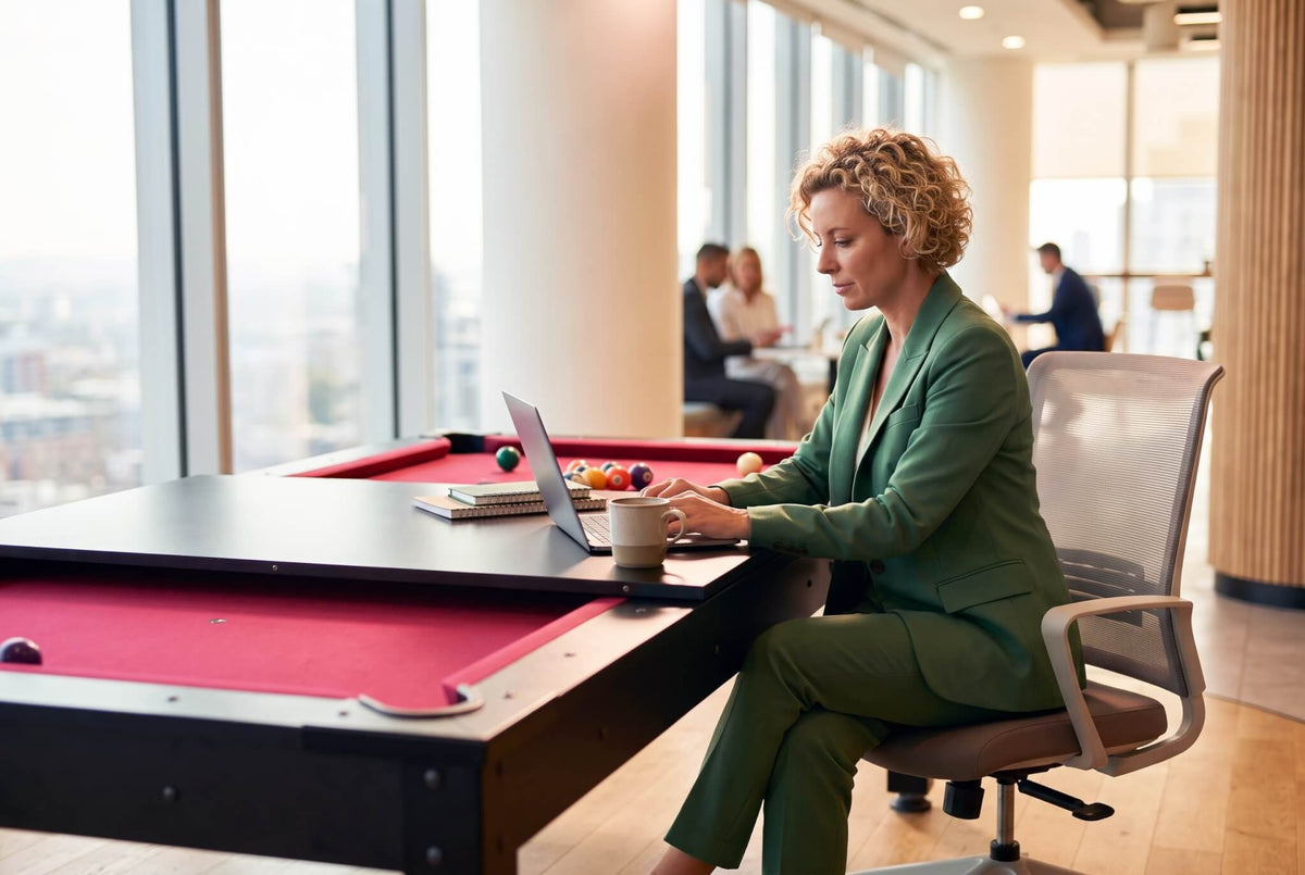 Woman working at a laptop on the black Heemskerk Richmond used as an office table