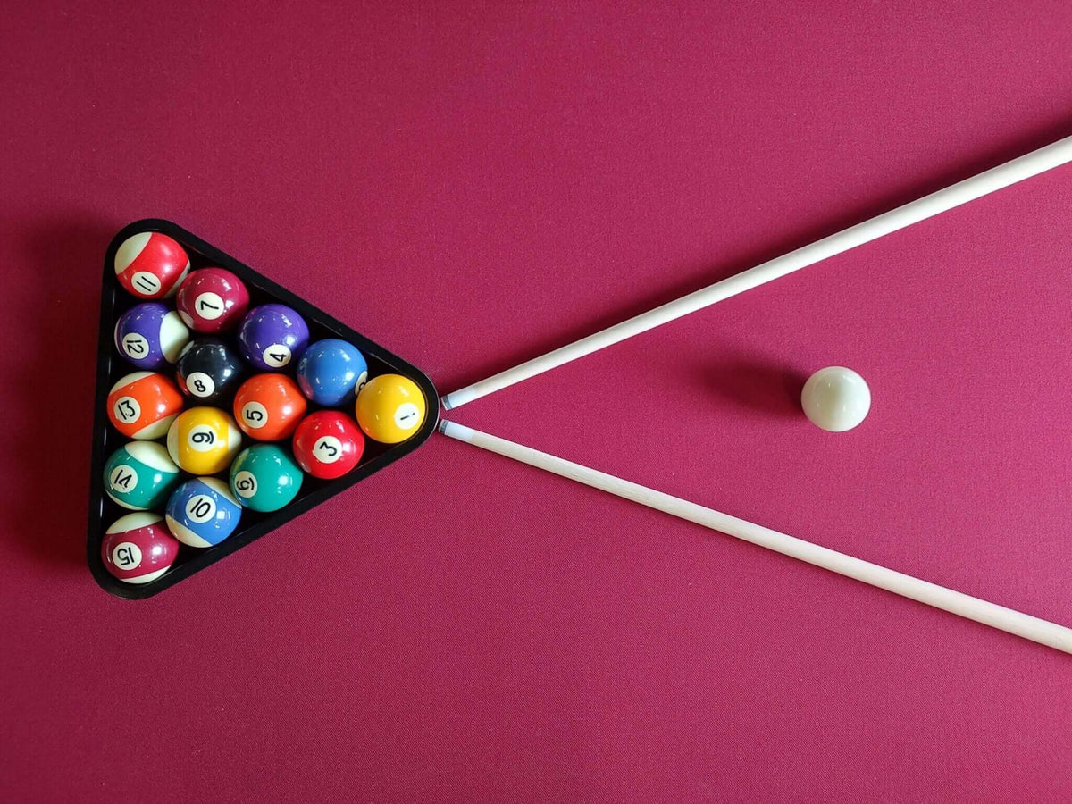 Pool balls racked in a triangle on the burgundy cloth of the Heemskerk Richmond
