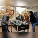 Students playing on a Heemskerk Soccer School football table in a school corridor