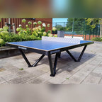Heemskerk Tango outdoor table tennis table installed on paving next to a sports court