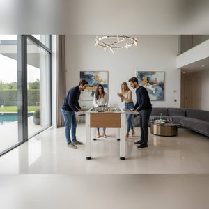 Four friends playing on a Heemskerk Vittorio football table in a modern living room