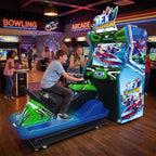 Teenager riding Jet Blaster at a bowling alley in the evening while a friend cheers