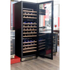 Kaiser Art Deco 3 zone wine cooler with the door open in a showroom, filled with wine bottles