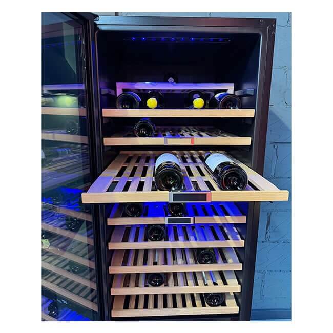 Pull-out wooden shelf extended from a Kaiser Art Deco wine cooler, holding wine bottles