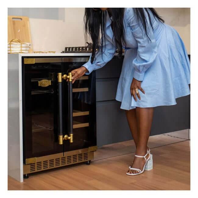 Woman opening a Kaiser Art Deco beer and wine cooler in a kitchen