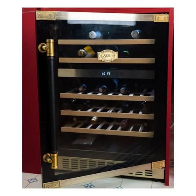 Kaiser Art Deco wine fridge with leather handle and gold kick plate, filled with bottles