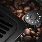 Close-up of the five-setting coffee grinder dial surrounded by coffee beans
