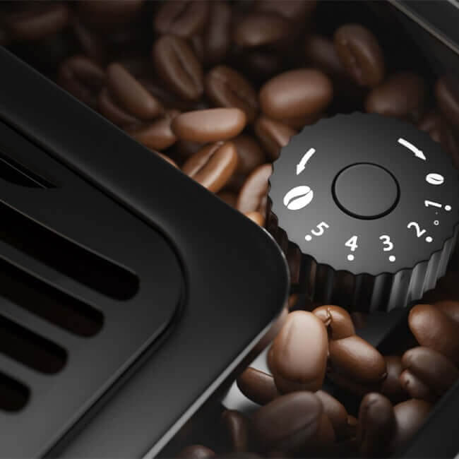 Close-up of the five-setting coffee grinder dial surrounded by coffee beans