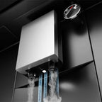 Close-up of the coffee machine's dispenser with steam and hot water pouring