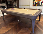 Side view of a dark brown leather Luxury Dandy pool table with sand cloth