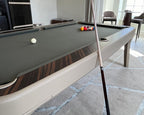 Ivory leather frame and grey cloth on the Luxury Dandy with a cue resting on the rail
