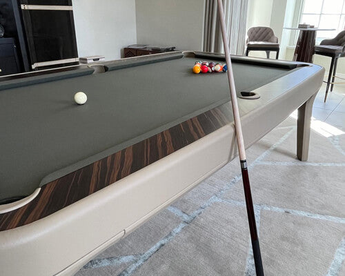 Ivory leather frame and grey cloth on the Luxury Dandy with a cue resting on the rail