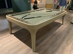 Luxury Dandy pool table in beige leather with sage green cloth in a showroom