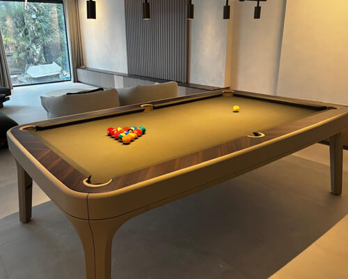 Luxury Dandy pool table in taupe leather with camel cloth in a modern living room
