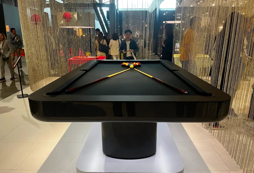 End view of the black Luxury Mono pool table with crossed cues