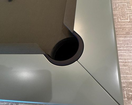 Close-up of a corner pocket and sage grey lacquered top rail on the Luxury Newde