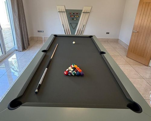Top view of the Luxury Newde with racked balls and a matching cue rack behind