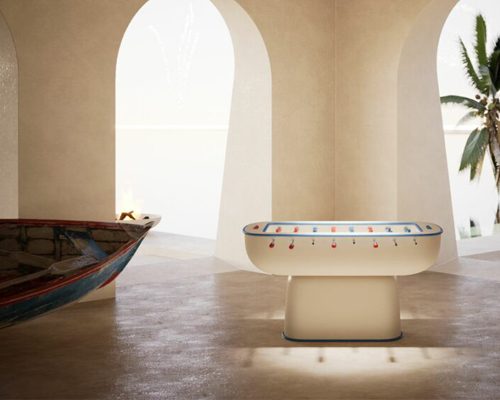 Luxury Oskar football table in cream lacquer in a room with arched walls