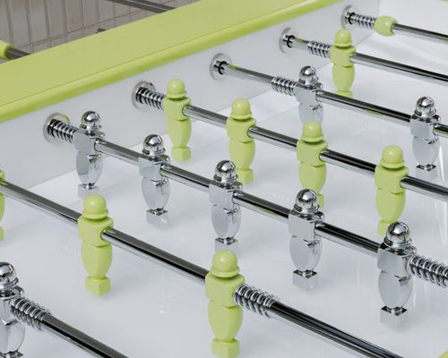Lime green and chrome players over the glass playing field of the Luxury Oskar