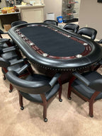 Luxury 96 x 48 inch oval poker table seating 10, with black playing surface, hardwood racetrack and leather chairs