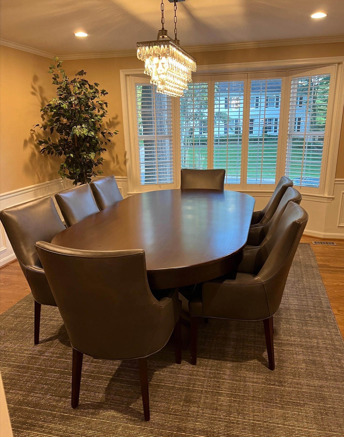 Luxury oval poker table with the wooden dining cover fitted, seating 10 in a dining room