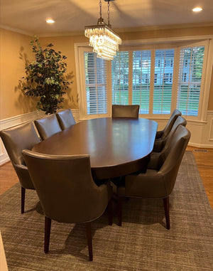 Luxury oval poker table with the wooden dining cover fitted, seating 10 in a dining room
