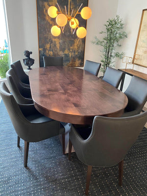Luxury oval poker table with the wooden dining cover fitted, used as a dining table with leather chairs
