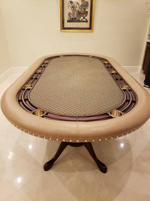 Luxury oval poker table with tan leather rail, brass studs, mahogany racetrack and brass cupholders on a pedestal base