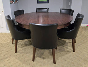 Luxury round poker table with the wooden dining cover fitted, set with black leather chairs