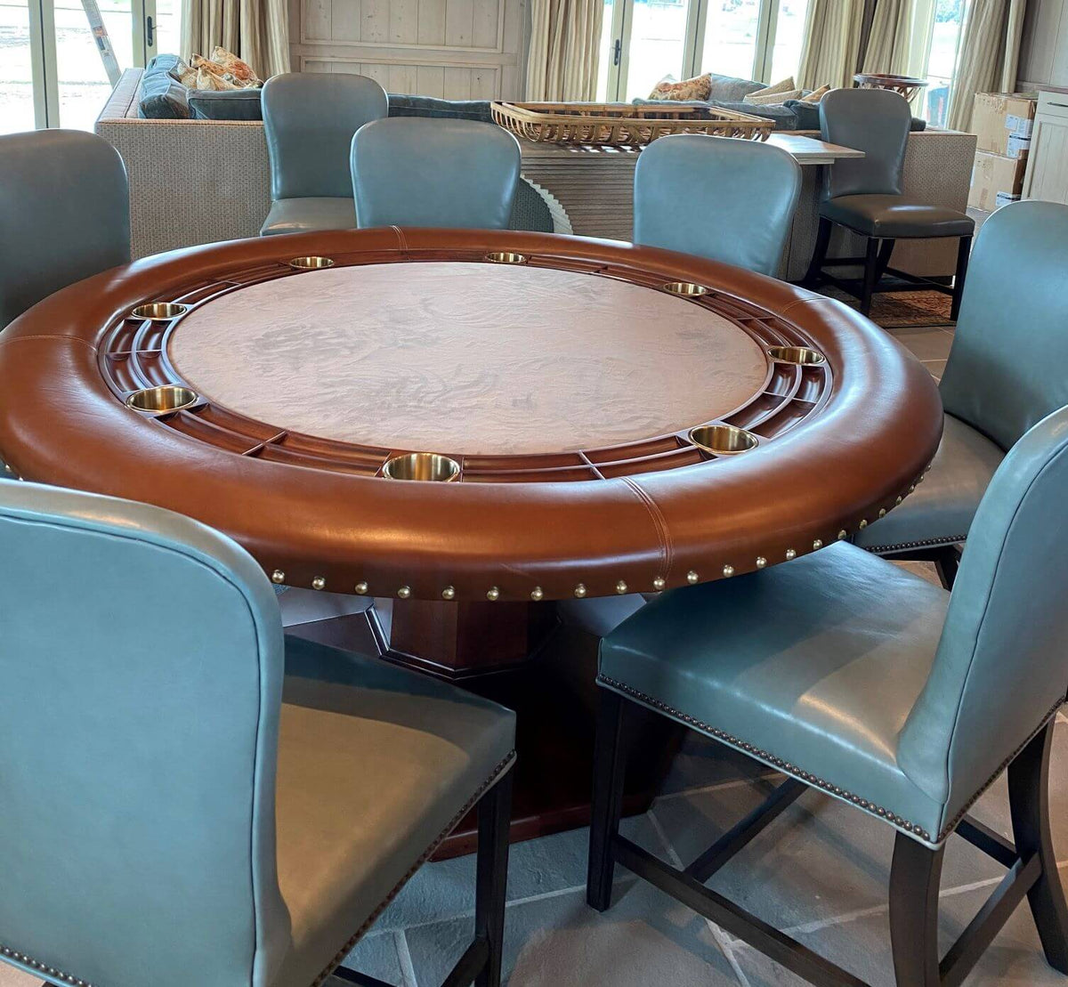 Luxury round poker table with mahogany racetrack and pedestal base, with chairs