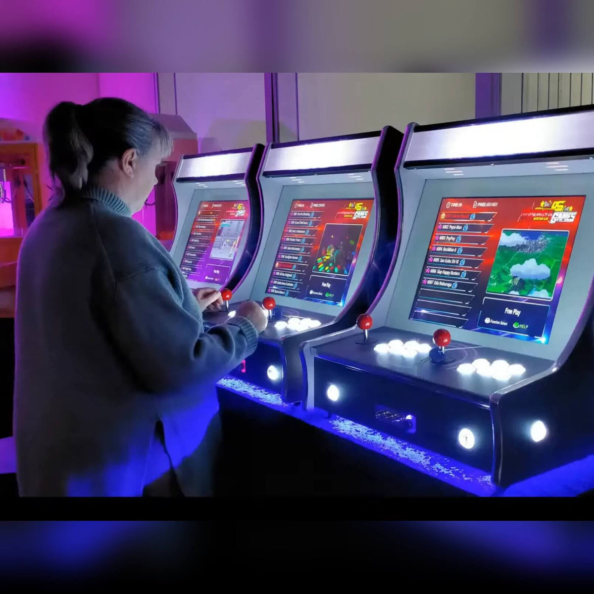 Row of bartop arcade machines with blue under-lighting
