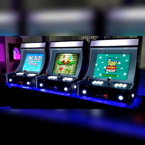 Bartop arcade machines lined up on a counter