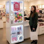A woman beside the capsule vending kiosk in a shopping centre