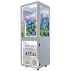 White MadeForArcade capsule vending kiosk with neon lighting and a locked display box