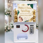Counter-top gashapon machine with a wedding poster in its lightbox