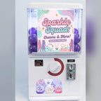 Counter-top gashapon machine with a lightbox poster and a clear capsule window