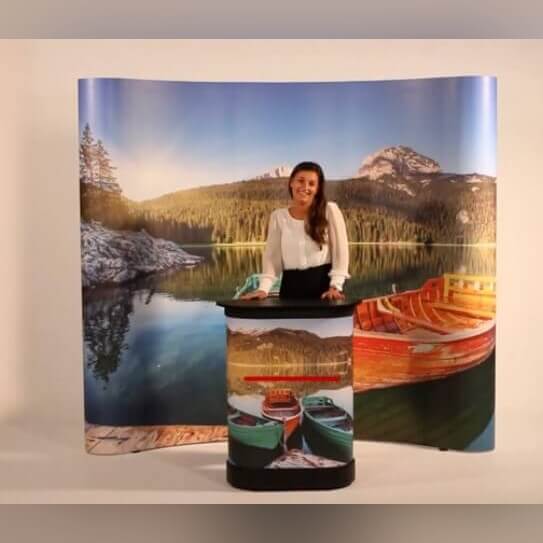 Branded curved backdrop with a presentation desk