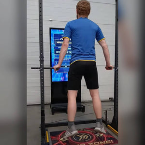A man hanging from the bar on the dead hang challenge
