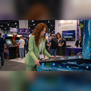 A woman playing a Flippatastic 43 inch virtual pinball machine at a busy trade show