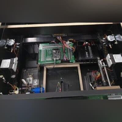 Inside the FlipperFury cabinet, showing the force-feedback solenoids and electronics