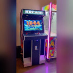 Full-size arcade machine glowing in a dark room