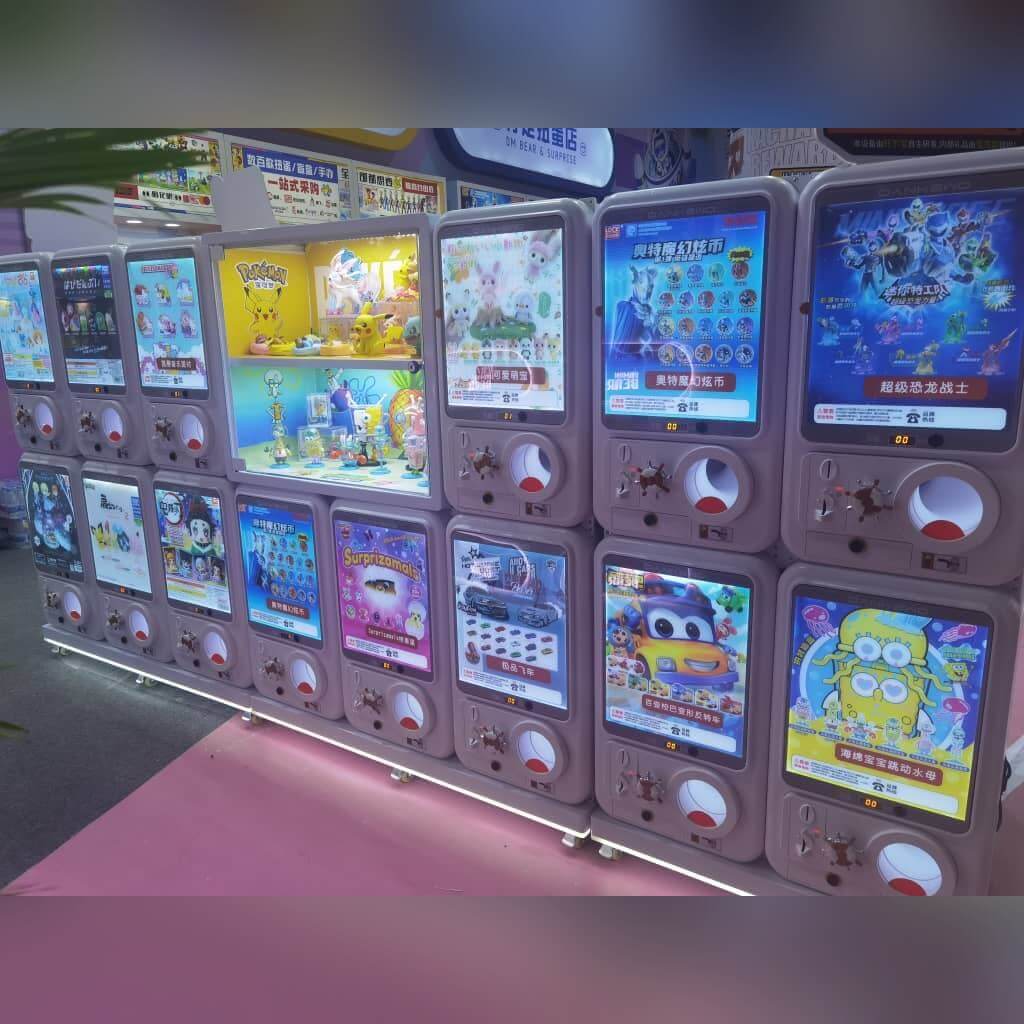 Row of GashaGold gashapon machines lit up in a shop