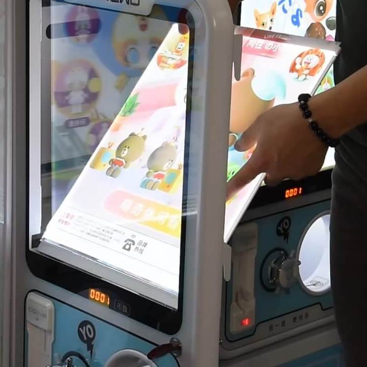 Hand turning the dial on a GashaGold gashapon machine