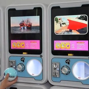 Two GashaGold gashapon machines side by side with lit posters