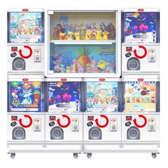 MadeForArcade gashapon vending wall with six capsule machines and a lit centre display case